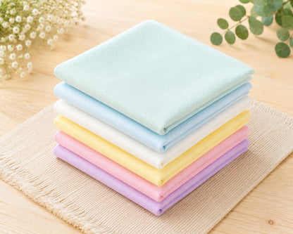 Stack of colorful hanky on a wooden surface with a natural background