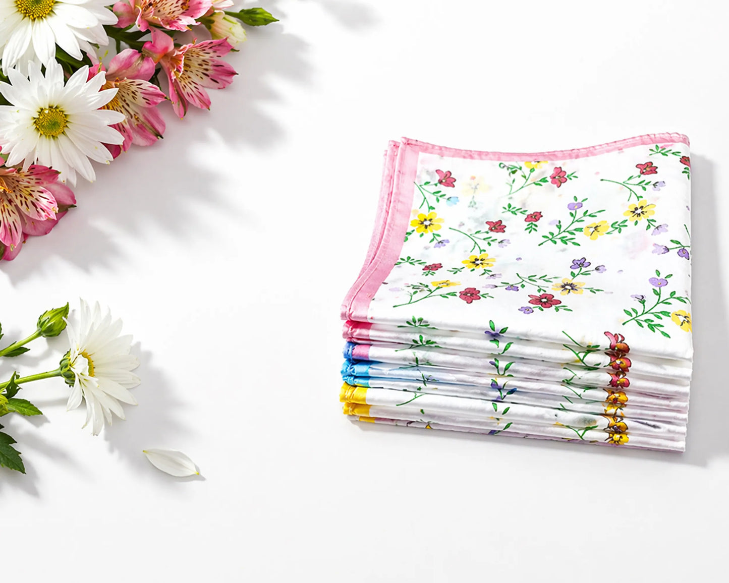Stack of floral-patterned women hanky with flowers on a white background