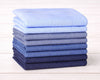 Stack of folded blue fabric hanky on a wooden surface