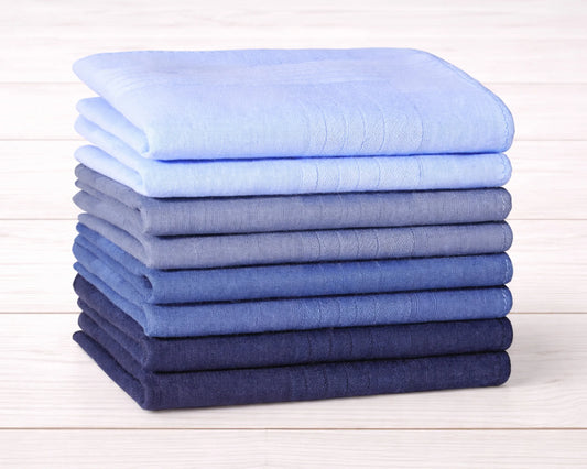 Stack of folded blue fabric hanky on a wooden surface