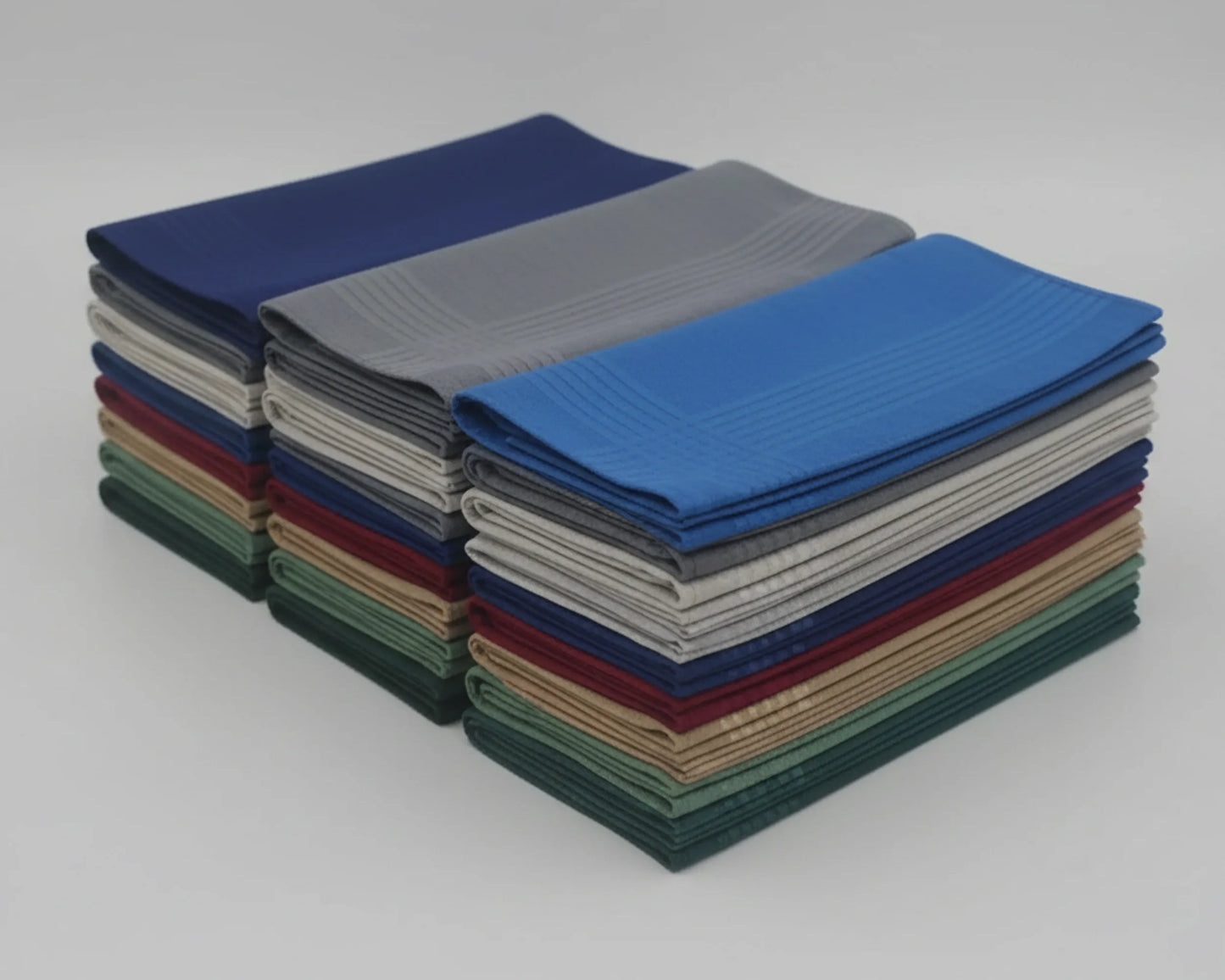 Stack of folded hanky in various colors on a white background