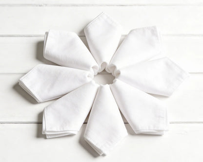 Stack of folded hanky in orange, green, and beige on a white background