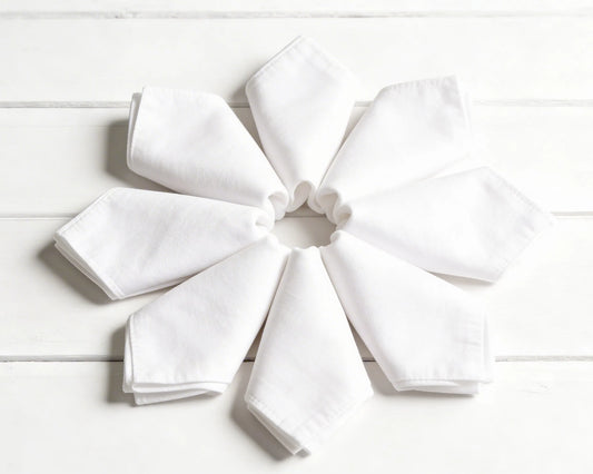 Stack of folded hanky in orange, green, and beige on a white background