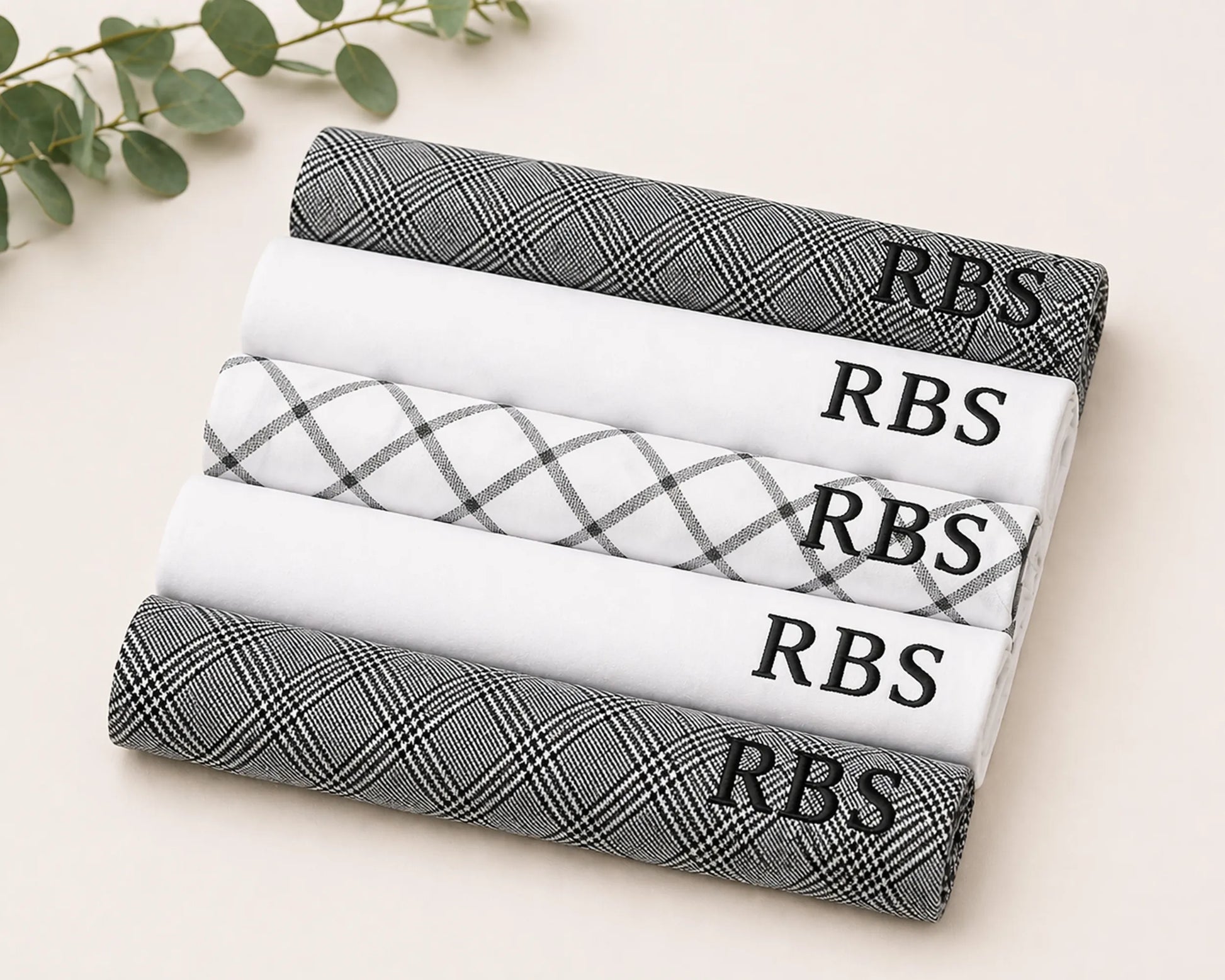 Stack of hanky rolls with 'RBS' branding on a light background