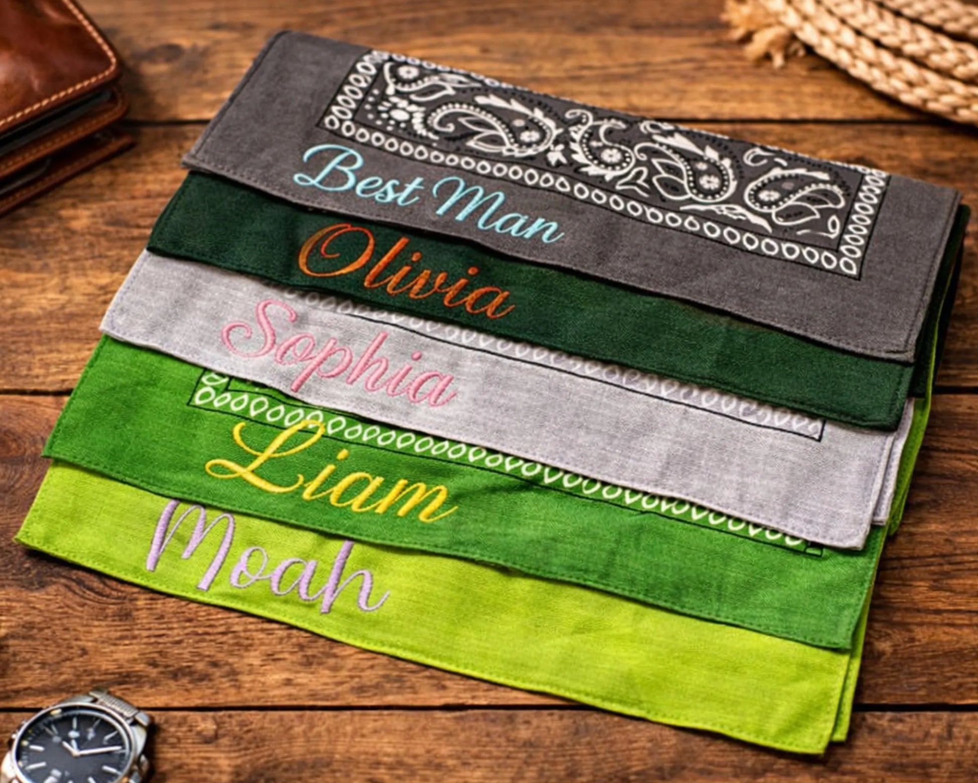 Stack of personalized bandanas on a wooden surface