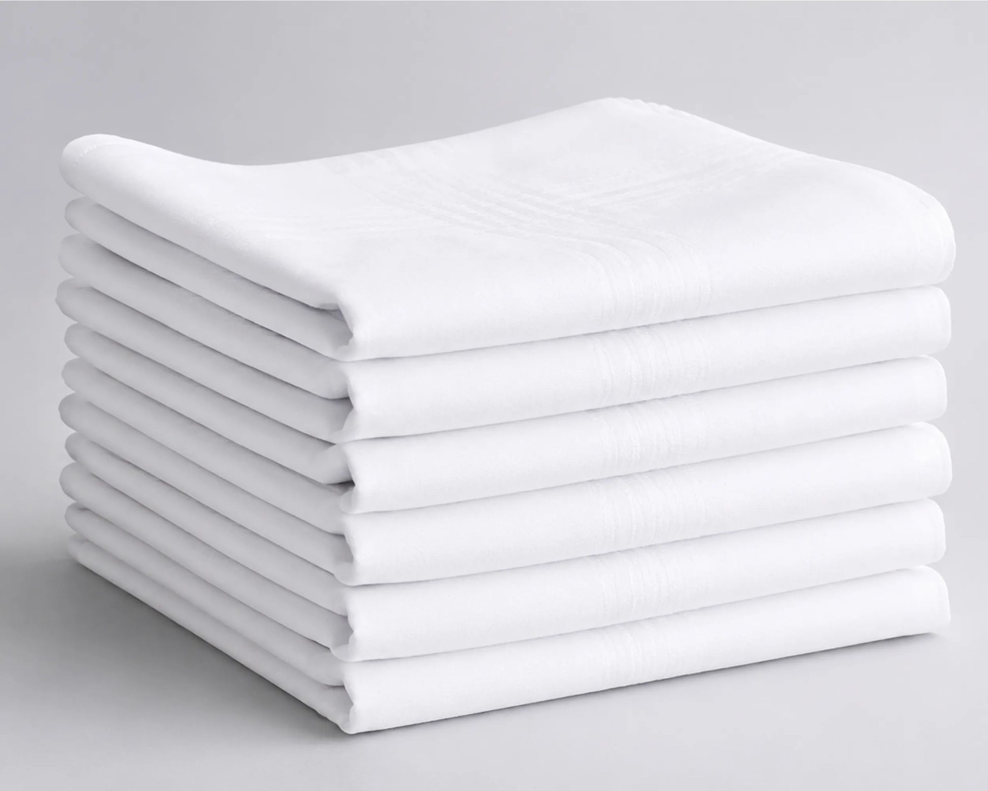 Stack of white folded hanky on a gray background