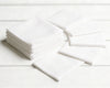 Stack of white hanky on a light wooden surface