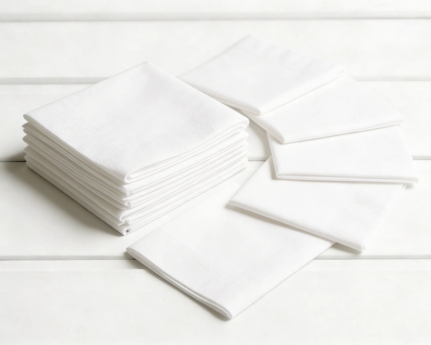 Stack of white hanky on a light wooden surface