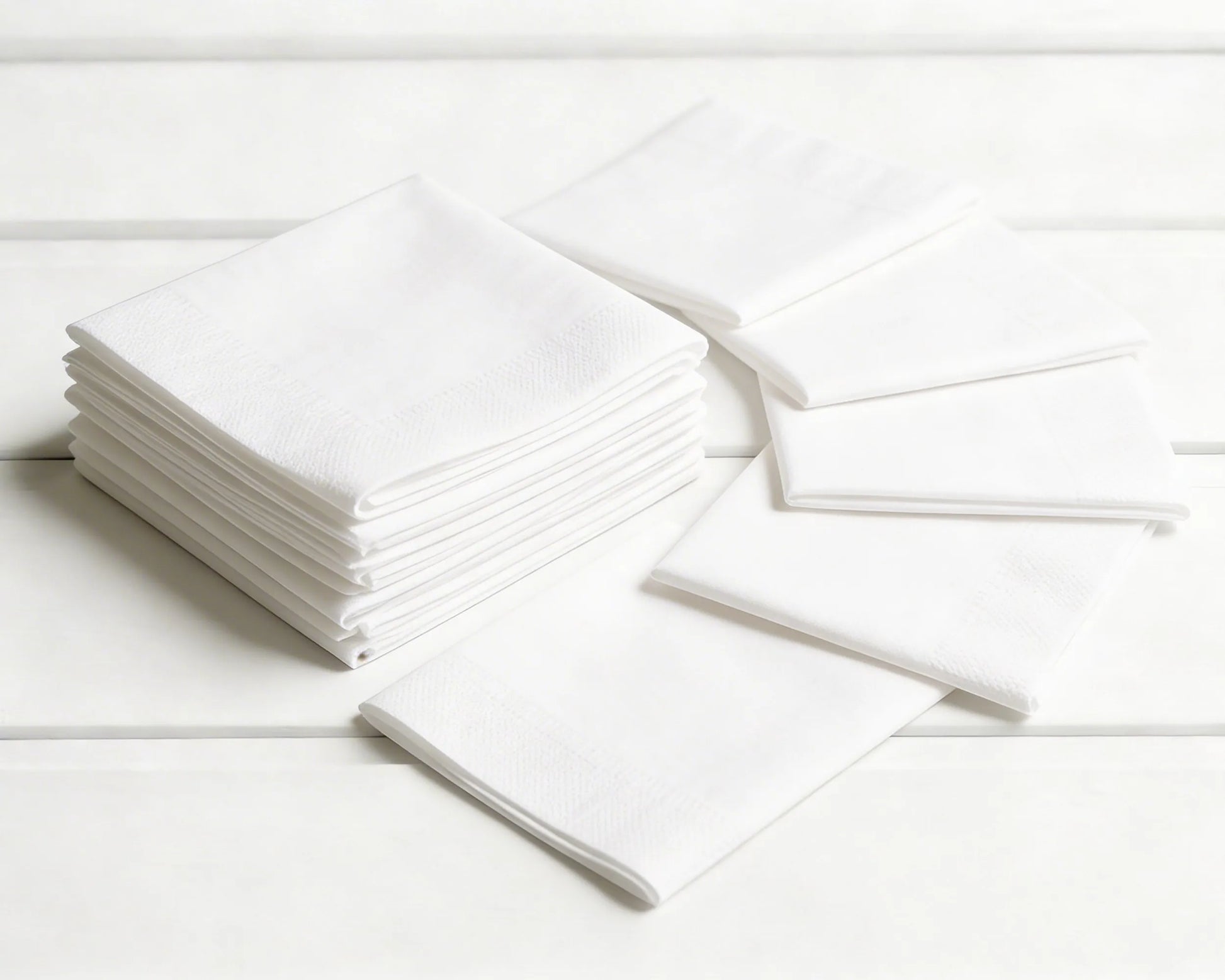 Stack of white hanky on a light wooden surface