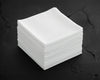 Stack of white hanky on a dark surface