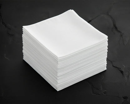 Stack of white hanky on a dark surface