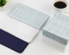 Stack of white hanky on a light wooden surface