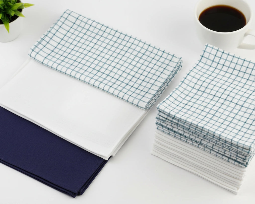 Stack of white hanky on a light wooden surface