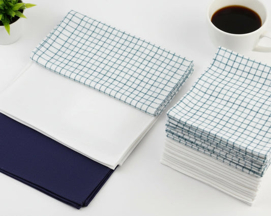Stack of white hanky on a light wooden surface