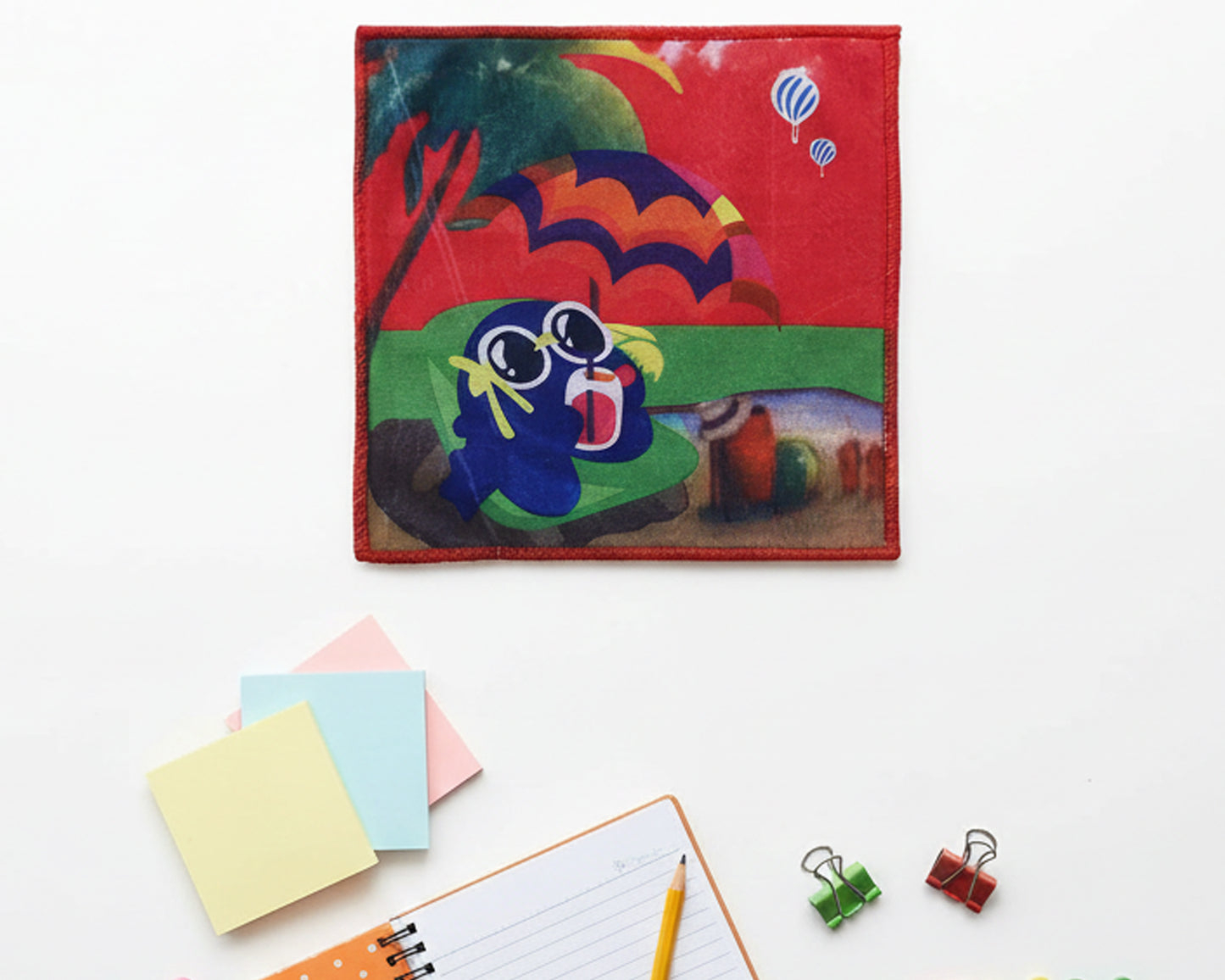 Vibrant red children’s handkerchief with a cartoon character at the beach under a parasol