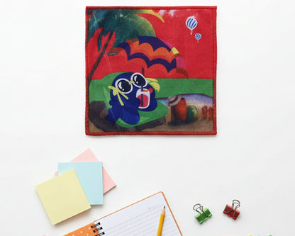 Vibrant red children’s handkerchief with a cartoon character at the beach under a parasol