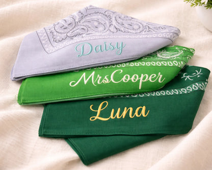 Three bandanas with embroidered names on a light background