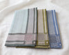 Three patterned hanky stacked on a white surface