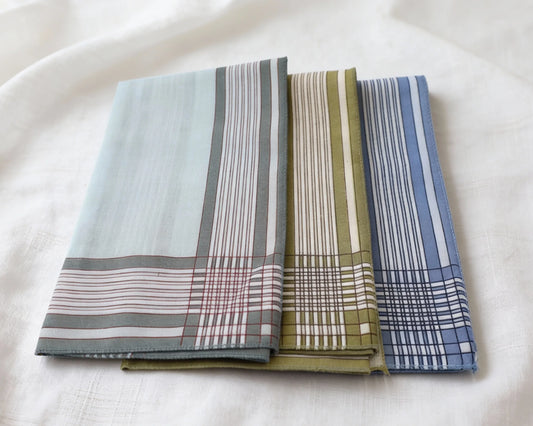 Three patterned hanky stacked on a white surface