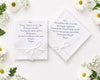 Two wedding handkerchief with heartfelt messages on a white surface surrounded by flowers