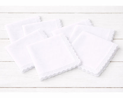 Two white  hanky on a light wooden surface