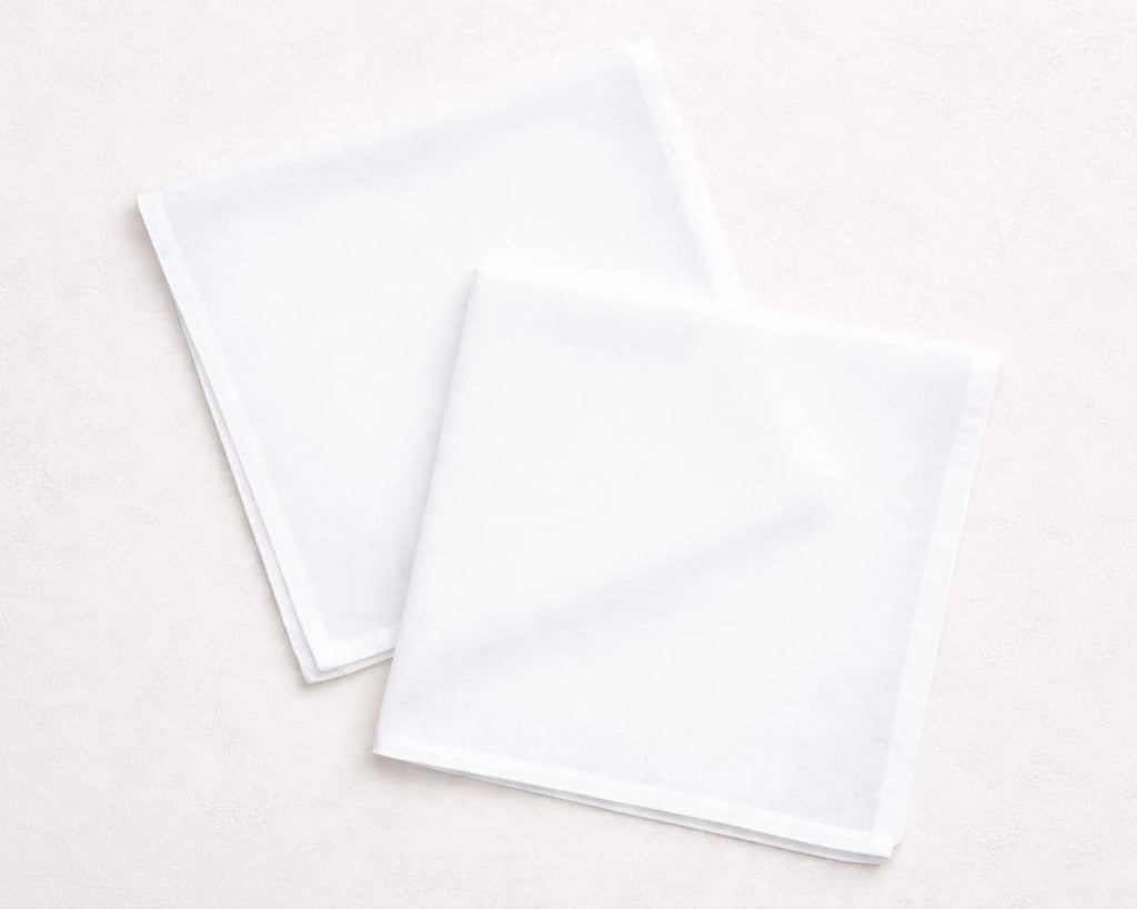 Two white hanky on a light beige background