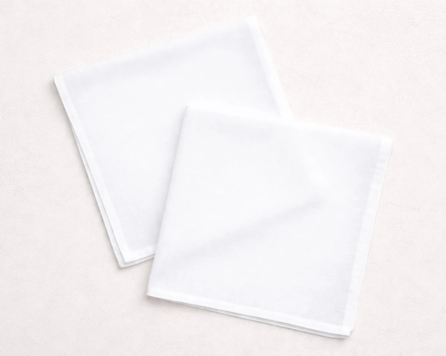Two white hanky on a light beige background