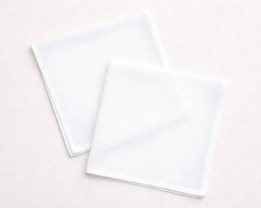 Two white hanky on a light beige background