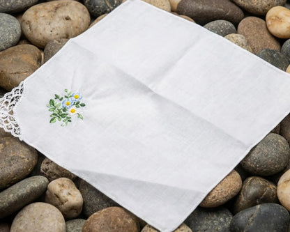 White embroidered handkerchief on a bed of stones