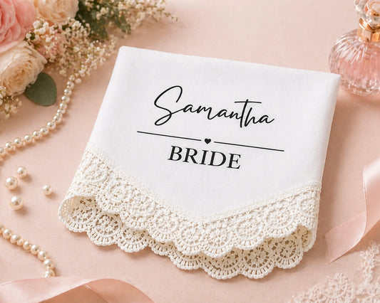 White handkerchief with 'Samantha BRIDE' text on a pink background with flowers and jewelry.