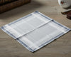 White handkerchief with blue border on a wooden surface