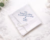 White handkerchief with embroidered message on a marble surface