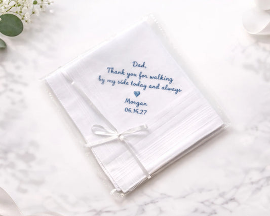 White handkerchief with embroidered message on a marble surface