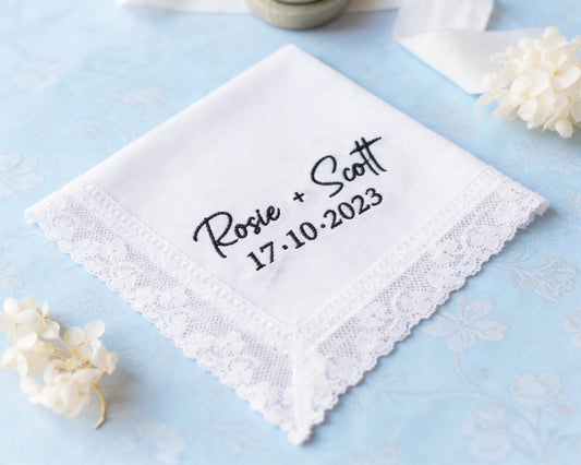 White handkerchief with embroidered text on a light blue background