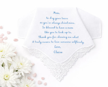 White handkerchief with embroidered text and flowers on a white background