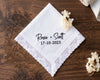 White handkerchief with personalized text on a wooden surface with floral decorations