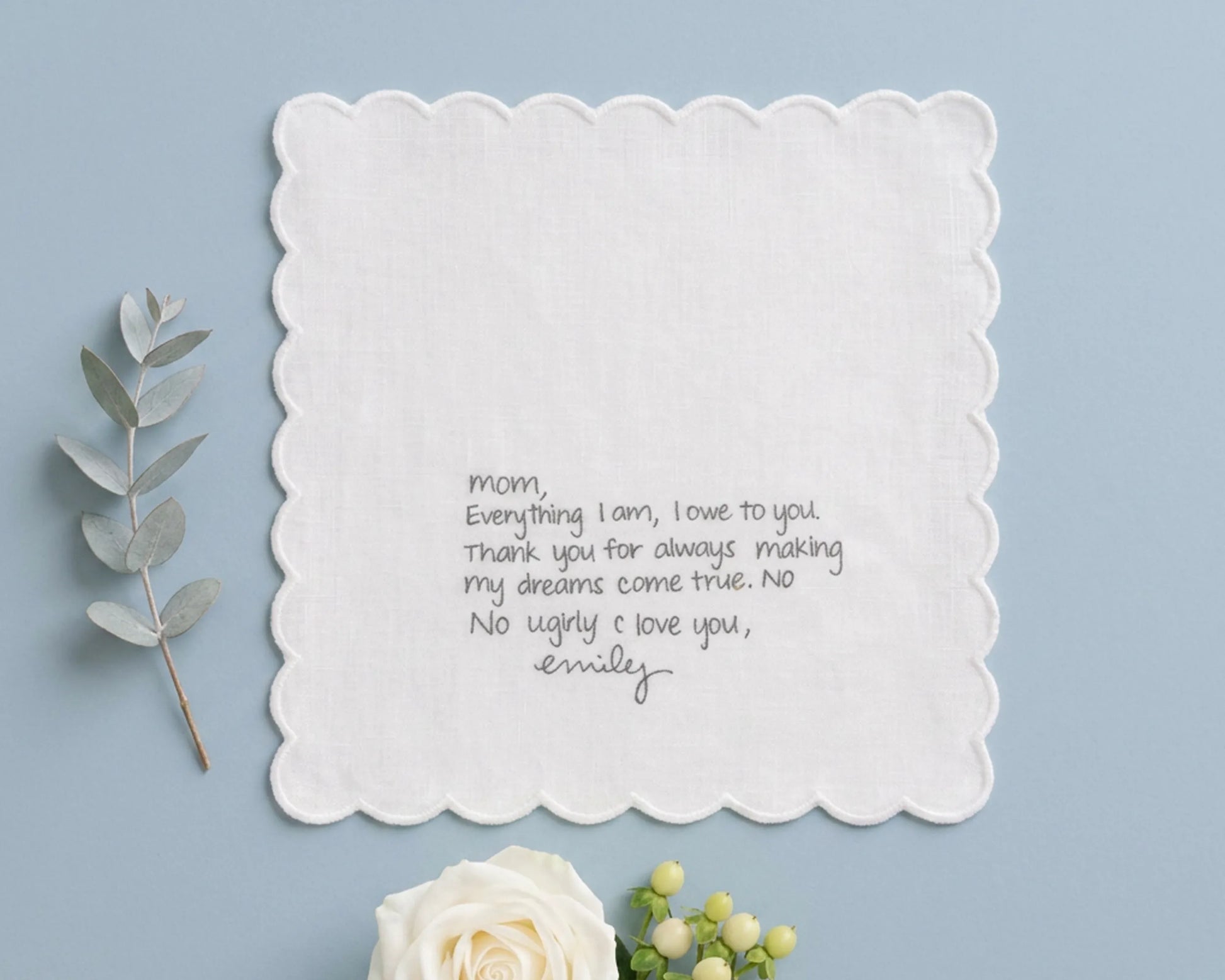 White hanky with a heartfelt message on a light blue background