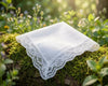White lace handkerchief on a mossy log with a natural background