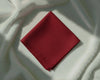 Red fabric square on a textured white surface