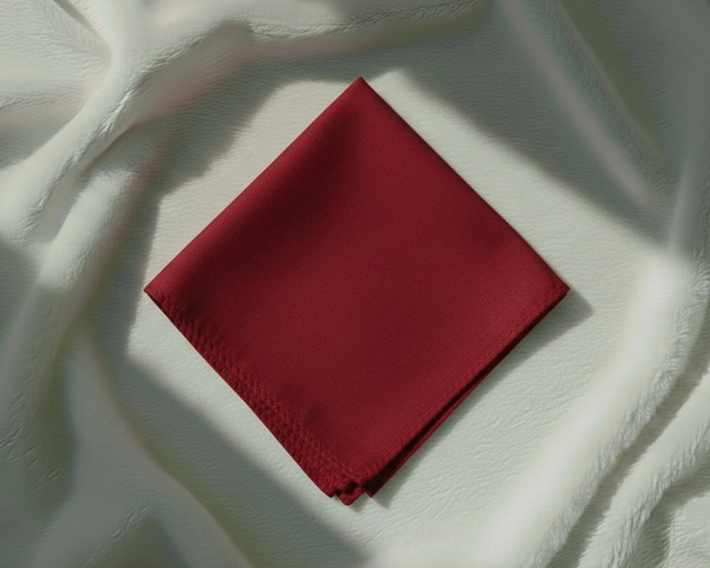 Red fabric square on a textured white surface