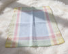 Pastel checkered hanky on a fluffy white surface
