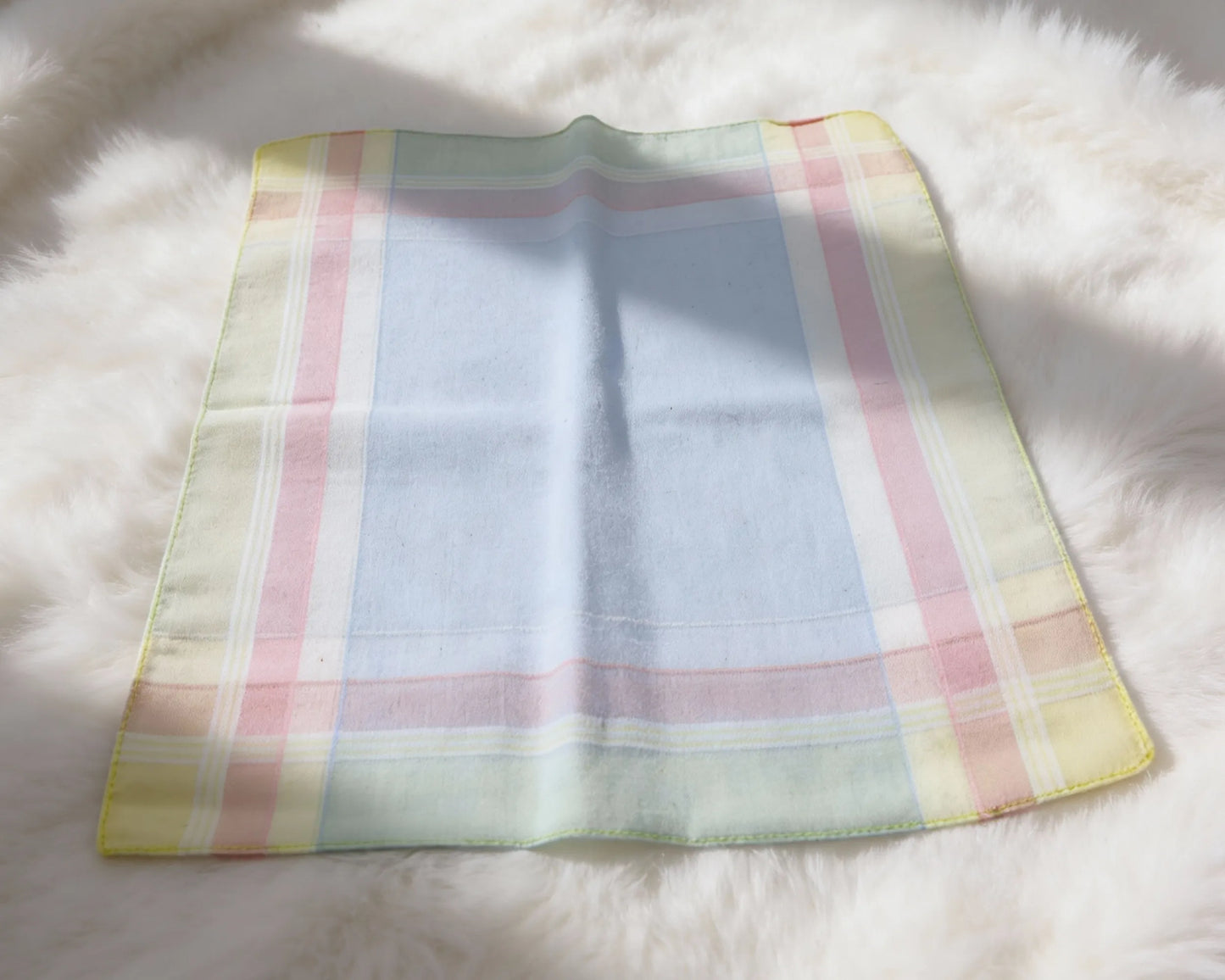 Pastel checkered hanky on a fluffy white surface