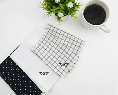 Three custom cotton handkerchiefs in navy plaid white diamond and solid blue patterns with red diamond monogrammed initials.