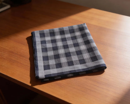 Folded checkered fabric on a wooden surface