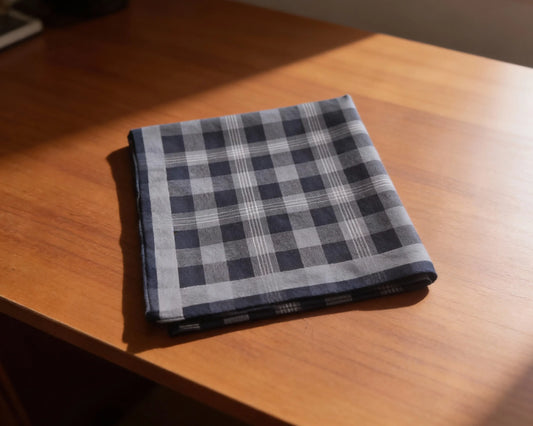 Folded checkered fabric on a wooden surface