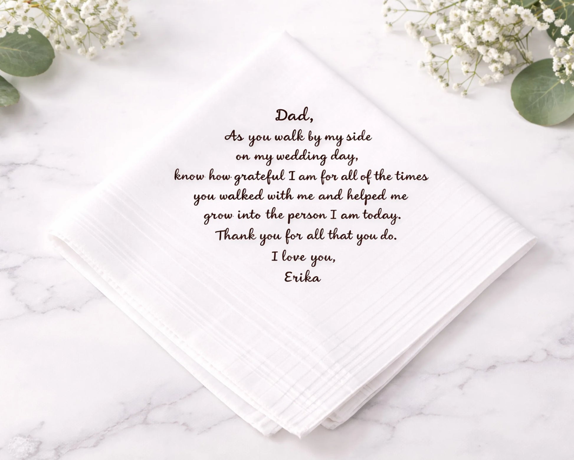 hankie card with heartfelt message to a father on a marble surface with flowers.