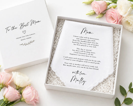 hanky in a box with a message for 'Mom' surrounded by pink flowers on a white surface