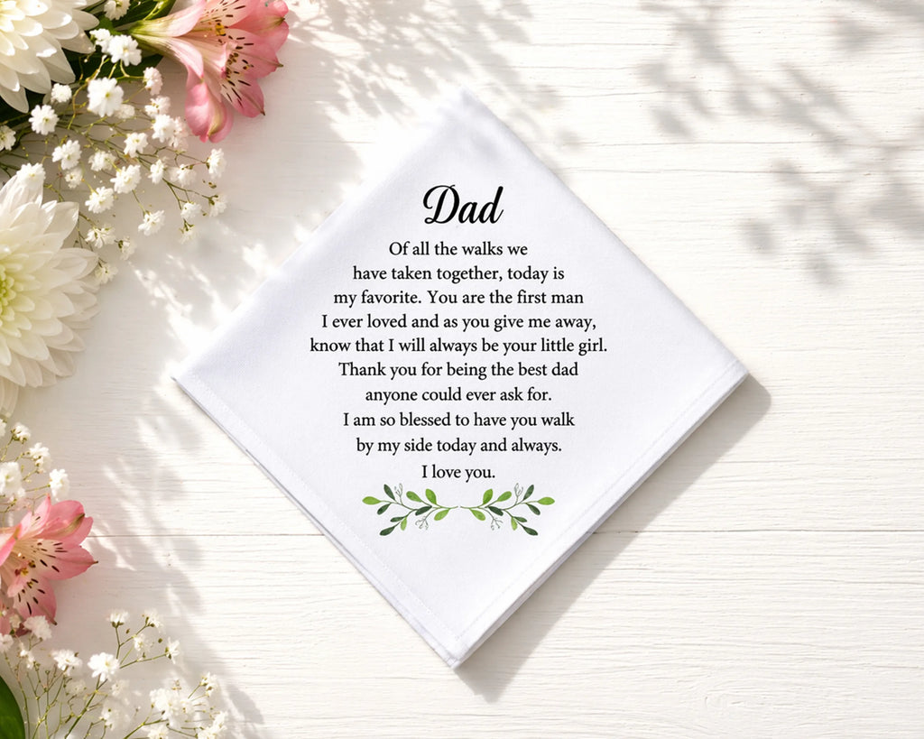hanky with a message for Dad surrounded by flowers on a light surface