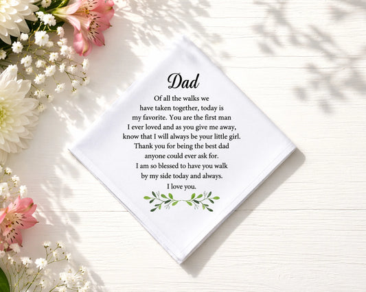 hanky with a message for Dad surrounded by flowers on a light surface