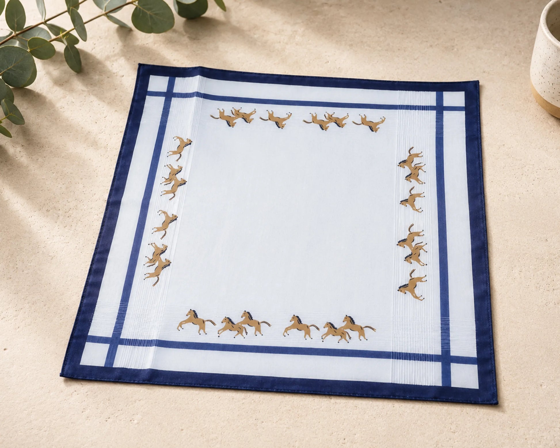hanky with horse design on a beige surface